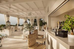 a lobby with a bar with chairs and plants at Tenuta Del Poggio Antico in Ischia