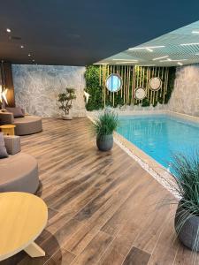 a swimming pool in a hotel room with a pool at Rtanj Kopaonik Eco Resort & Spa in Kopaonik