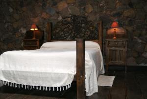 Un pat sau paturi într-o cameră la Caserio Los Partidos