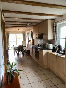 a large kitchen with a table and a couch at Pfaffensteghof in Rickenbach