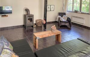 a living room with a couch and a wood stove at 1 Bedroom Beautiful Home In Boekelo in Boekelo