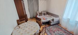 a room with a bed and a table and a chair at Budget One Room Apartment in Baku