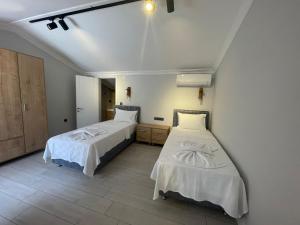 Postel nebo postele na pokoji v ubytování Kaya Koy Tatil Evleri Villas + 64 fotografií
