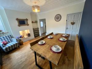 a living room with a wooden table and a couch at Lovely 3BD Home in the Heart of Morton in Morton