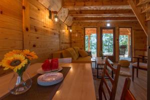 a dining room and living room of a log cabin at Log cabins Banjska stena in Mitrovac