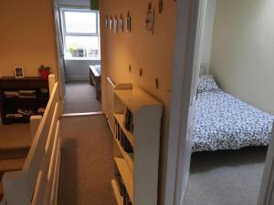 a room with a bedroom with a bed and a staircase at Wonderfully Cosy 3BD Home in the Heart of Cornwall in St Austell