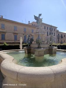 a large fountain in front of a building at A Casa di Marti in Loreto