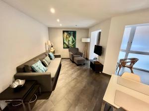 uma sala de estar com um sofá e uma cadeira em GORGEOUS APARTMENT IN DOWNTOWN em Barcelona