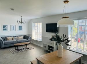 a living room with a couch and a table at The Terrace - Tankerton in Kent