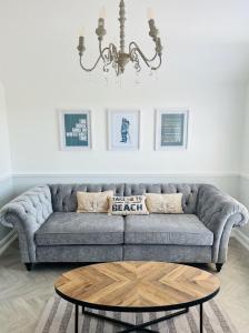 a living room with a couch and a coffee table at The Terrace - Tankerton in Kent