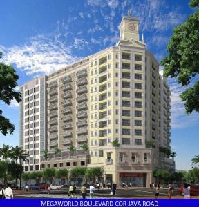 a large white building with a clock tower on top at Iloilo Staycation with a Pool, Gym and Playroom in Iloilo City