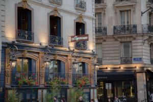 a building with flowers in front of a store at Le Notre Dame - Luxury Apartment with Seine View in Paris