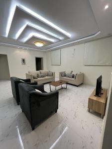 a large living room with couches and a table at Albashier private apartment in AlUla