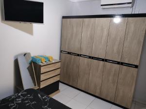 a large wooden cabinet with a television on the wall at Confort in Paso de los Libres