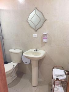 a bathroom with a sink and a toilet at Tababela Airport B&B in Tababela