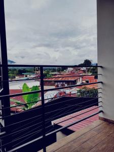 d'un balcon avec vue sur la rivière et les bâtiments. dans l'établissement Villas del General, à San Isidro de El General