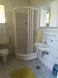 a bathroom with a shower and a sink at Apartments by the sea Zivogosce - Mala Duba, Makarska - 18626 in Igrane