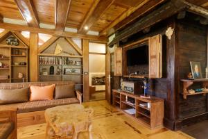 a living room with a couch and a tv at Mountain Villa Udovicic in Zlatibor