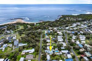 an aerial view of a suburb with a yellow cross at Seascape at The Cape in Cape Paterson