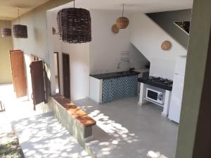 a kitchen with a bench in the middle of a room at Casa do Artista in Trancoso