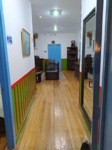 a hallway with a hard wood floor and a mirror at Hostel Camelot Salento in Salento