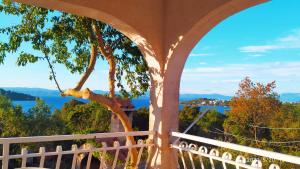 a view from the balcony of a house with a tree at Apartments by the sea Necujam, Solta - 18664 in Grohote
