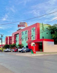 a hotel with a coke machine in front of a street at Hotel Veneza in Luis Eduardo Magalhaes