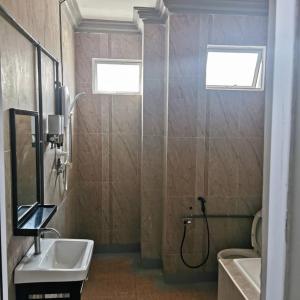 a bathroom with a shower and a sink and a toilet at Ourstay Nadi Kota in Bandar  Pusat Jengka