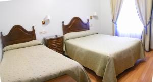 Posteľ alebo postele v izbe v ubytovaní Hotel Chipén