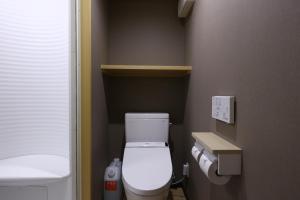 a small bathroom with a toilet and a sink at Onyado Nono Sendai Natural Hot Spring in Sendai