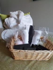 a basket filled with towels and other items on a bed at The Coach and Horses in Hexham +9 photos