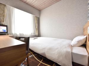 En eller flere senger på et rom på Hotel WBF Kushiro