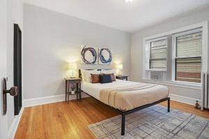 1 dormitorio con 1 cama y 2 espejos en la pared en 1BR Simple & Roomy Apartment in Evanston - Hinman S3, en Evanston