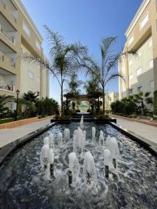 a group of white sculptures in the water in a fountain at Palm Lake Resort Folla Monastir/Sousse in Monastir