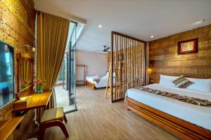 a hotel room with a bed and a balcony at Olala An Bang Villa in An Bang +65 photos