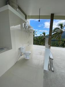 a white bathroom with a toilet and a balcony at Casa De Pueblo Japanese Shrine Unit 2 in Valencia