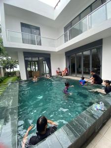 a group of people in a swimming pool in a house at Villa Zenna Long Hải - Mimosa 611 View Biển in Long Hai