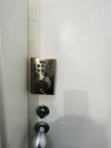 een deur met een luidspreker op een witte muur bij 408 Lovely one BR ex hotel ensuite room in city in Adelaide