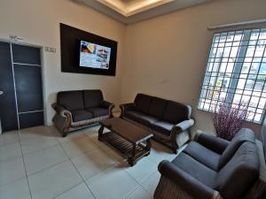 a waiting room with couches and a tv at My Hotel Bukit Mertajam in Bukit Mertajam