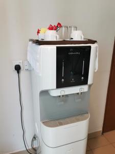 a microwave sitting on the back of a refrigerator at My Hotel Bukit Mertajam in Bukit Mertajam