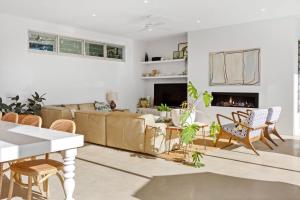 a living room with a couch and chairs at Poolside Paradise Mount Eliza in Mount Eliza