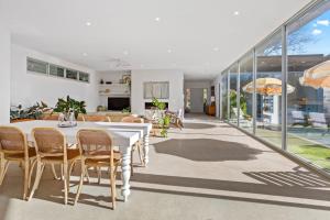 a dining room with a table and chairs at Poolside Paradise Mount Eliza in Mount Eliza