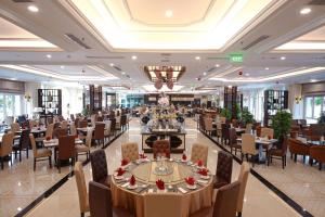 a banquet hall with tables and chairs in a restaurant at Ninh Binh Legend Hotel in Ninh Binh