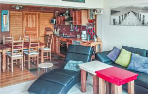a living room with a couch and a table at 3 Bedroom Gorgeous Home In Nowe Warpno in Nowe Warpno