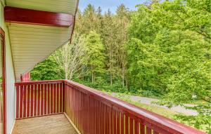 a red balcony of a house with a view of trees at Ferienhaus 39 In Kirchheim in Kirchheim +17 photos