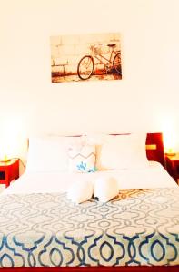 a bedroom with a bed with a bike on the wall at Softstone resort in Panglao Island