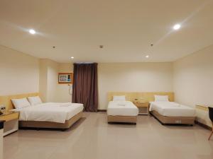 Ένα ή περισσότερα κρεβάτια σε δωμάτιο στο Kaizen Suites