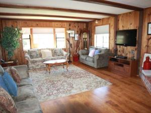 a living room with a couch and a tv at Ocean's Breeze, 4/bed, 3/ba, Game Room. Sleeps 10! in Morro Bay