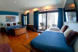 a bedroom with two beds and a large window at Natural Villas -Samet View with Private Pool in Rayong +21 photos