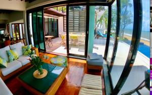 a living room with a couch and a table at Samet View Luxury Villa with Private Pool in Rayong